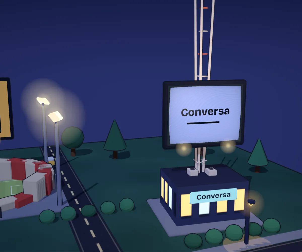 Conversa's building in the night town from the home page, its billboard playing the app